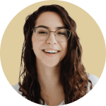 Portrait of Ilona, wearing glasses and smiling showing teeth